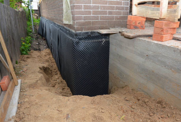 Happy homeowners after waterproofing job in Britton